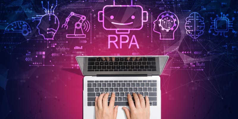 Robotic Process Automation(RPA) theme with person using a laptop computer illustrates the RPA developer salary in India.