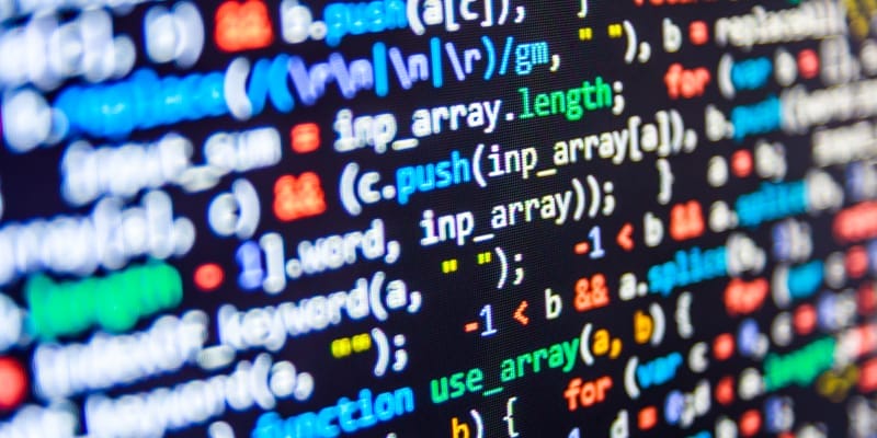 A programming code abstract explains the difference between scripting and programming languages.