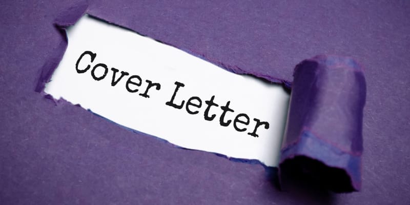 Cover letter text on a torn paper explains the crafting of a data analyst cover letter.